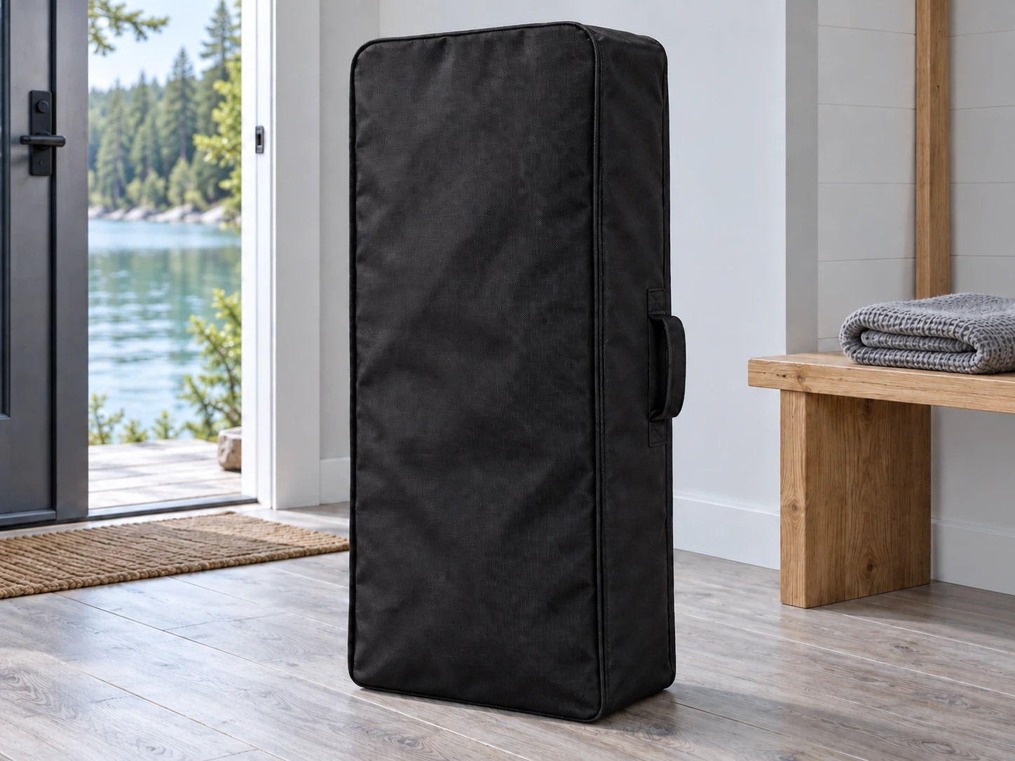 Closed black SUP carry bag stored indoors beside a bench, away from direct sun